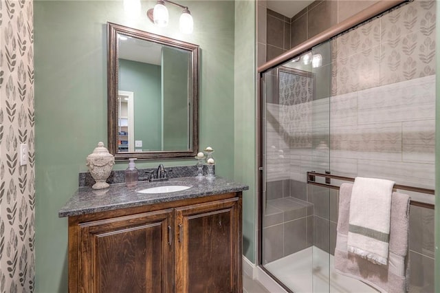 bathroom with a shower stall and vanity