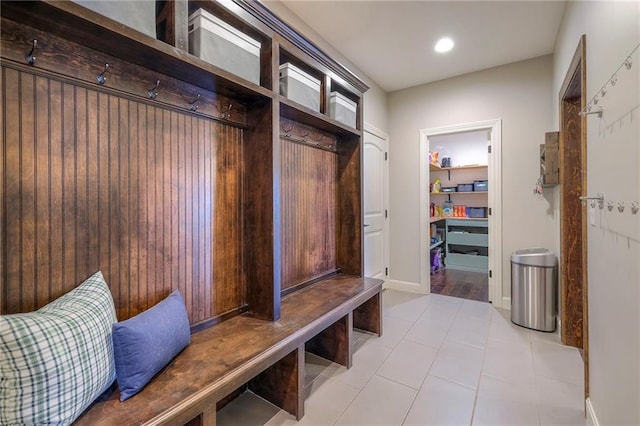 mudroom with light tile patterned floors and baseboards