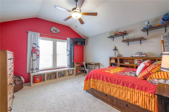 carpeted bedroom with vaulted ceiling and a ceiling fan