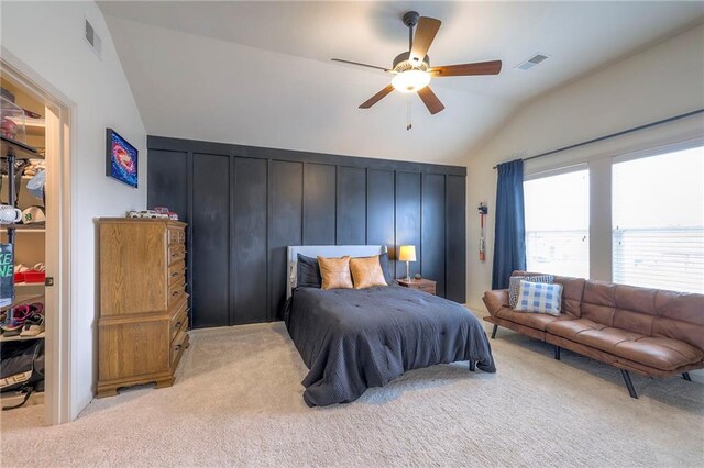 bedroom with vaulted ceiling, light carpet, visible vents, and a ceiling fan