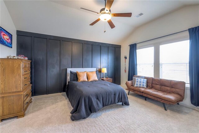 bedroom featuring lofted ceiling, ceiling fan, visible vents, and light colored carpet