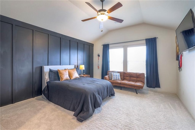 bedroom with carpet flooring, vaulted ceiling, and ceiling fan