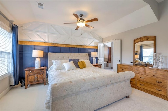 bedroom with lofted ceiling, visible vents, a ceiling fan, and light colored carpet