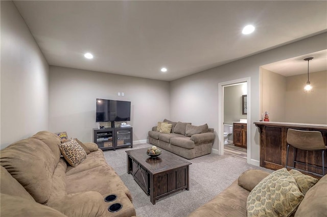 living room featuring light carpet, baseboards, and recessed lighting