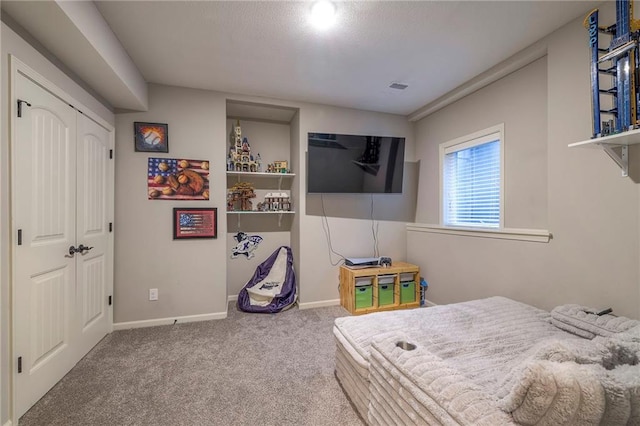 carpeted bedroom featuring visible vents and baseboards