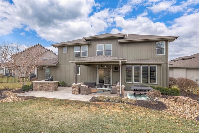 back of house with a yard, a patio, an outdoor kitchen, fence, and an outdoor living space