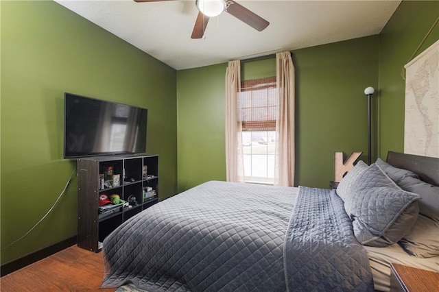 bedroom featuring wood finished floors and a ceiling fan