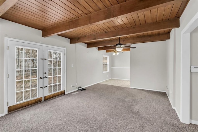 unfurnished room featuring a healthy amount of sunlight, wood ceiling, carpet floors, and french doors