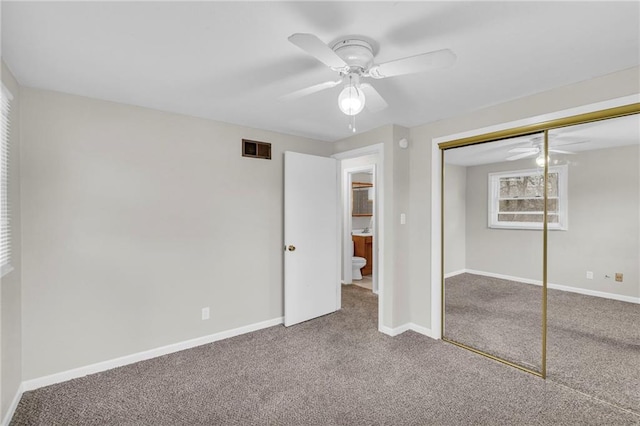 unfurnished bedroom featuring visible vents, a closet, baseboards, and carpet flooring