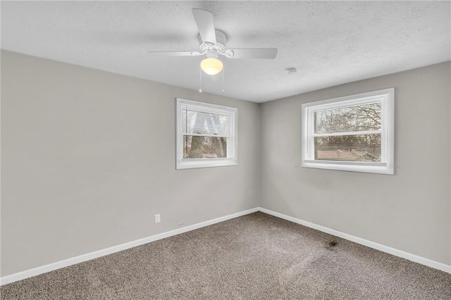 empty room featuring carpet floors, ceiling fan, a textured ceiling, and baseboards