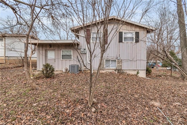 exterior space featuring board and batten siding and central AC