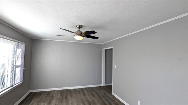 spare room featuring ornamental molding, dark wood finished floors, baseboards, and a ceiling fan