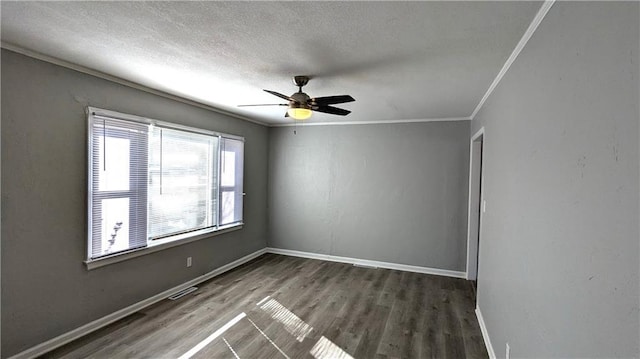 empty room with baseboards, ceiling fan, wood finished floors, crown molding, and a textured ceiling