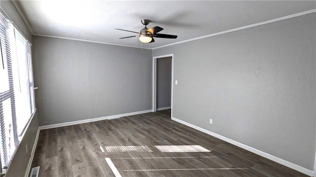 unfurnished room featuring ceiling fan, ornamental molding, wood finished floors, and baseboards