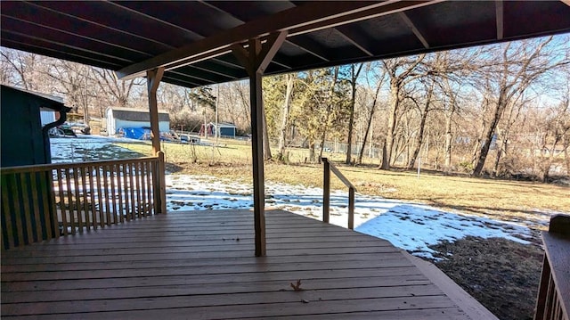 snow covered deck with a patio area