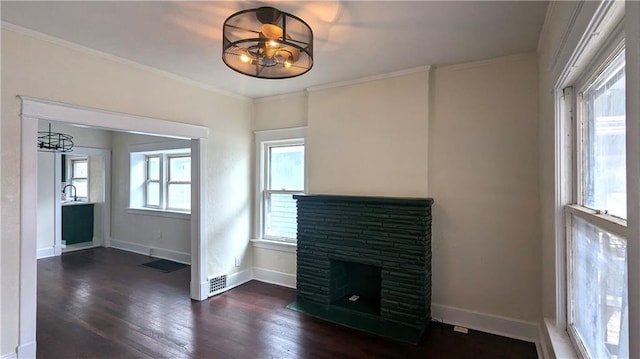 unfurnished living room featuring baseboards, a fireplace, ornamental molding, and dark wood-style flooring