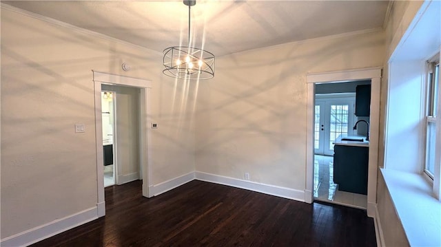 unfurnished dining area featuring a sink, baseboards, ornamental molding, and dark wood-style flooring