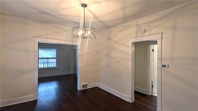 unfurnished dining area with a chandelier, visible vents, baseboards, dark wood finished floors, and crown molding