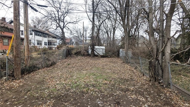 view of yard featuring a residential view and fence