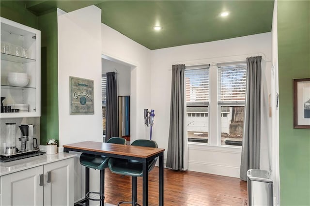 interior space featuring baseboards, dark wood-type flooring, and recessed lighting