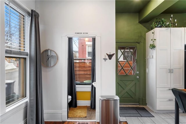 entryway featuring baseboards and a wealth of natural light