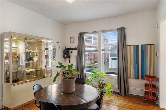 dining area with light wood-style floors and baseboards