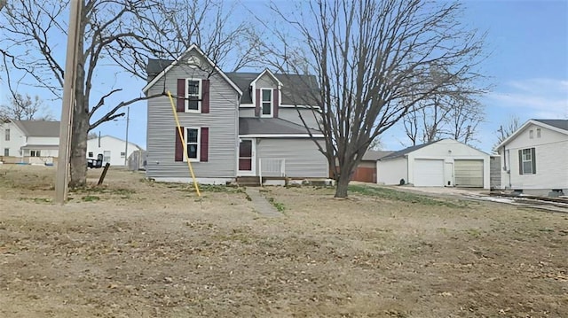 view of front of home with a residential view and an outbuilding