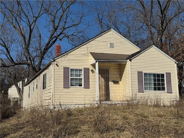 bungalow-style home featuring a chimney