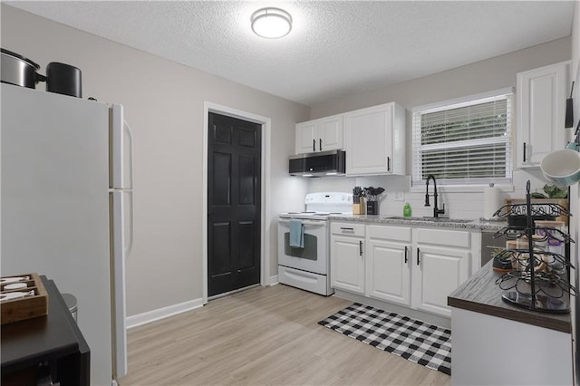 kitchen featuring tasteful backsplash, light wood-type flooring, white appliances, white cabinetry, and a sink