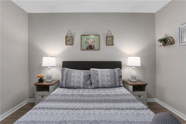 bedroom featuring dark wood-style floors and baseboards