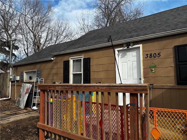 exterior space featuring roof with shingles