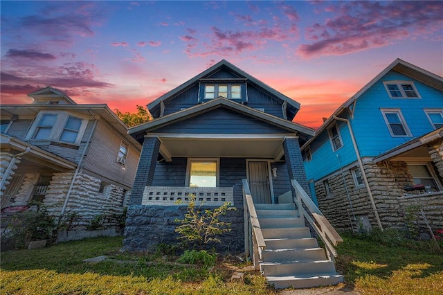 view of front of home featuring covered porch and stairway