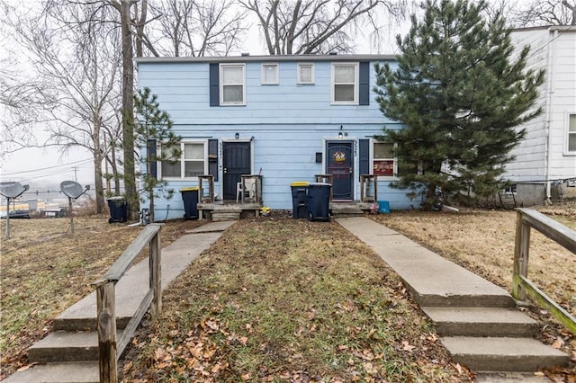 view of front of home featuring fence