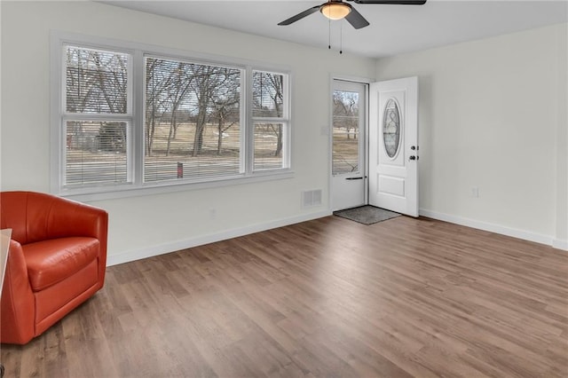 entrance foyer featuring ceiling fan, wood finished floors, visible vents, and baseboards