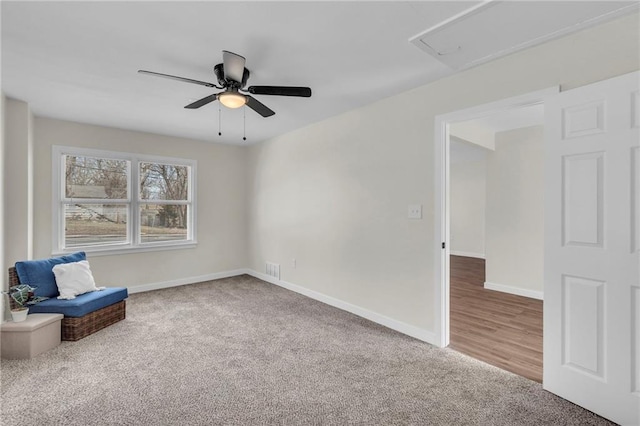 unfurnished room featuring carpet flooring, ceiling fan, visible vents, and baseboards