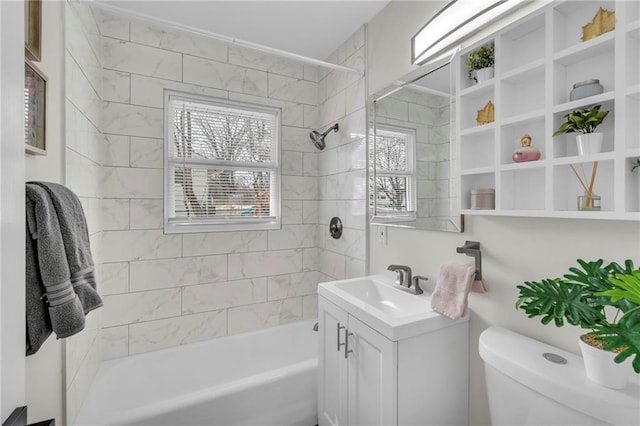 bathroom featuring washtub / shower combination, vanity, and toilet