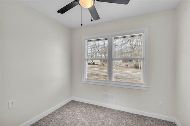 empty room featuring baseboards, visible vents, ceiling fan, and carpet flooring