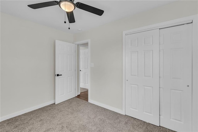 unfurnished bedroom featuring carpet floors, a closet, ceiling fan, and baseboards