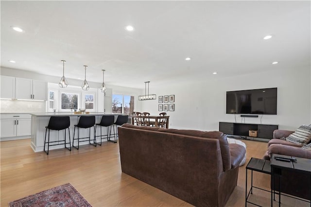 living area featuring light wood-style floors and recessed lighting