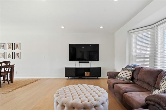 living area with recessed lighting, wood finished floors, and baseboards