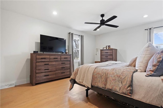 bedroom featuring light wood-style floors, baseboards, visible vents, and recessed lighting