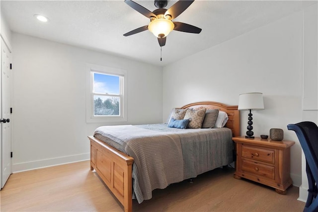 bedroom featuring ceiling fan, recessed lighting, light wood-type flooring, and baseboards