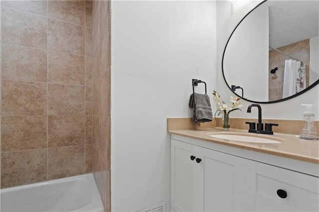 bathroom featuring vanity, a shower with shower curtain, and a bath