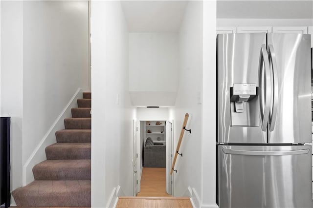 stairs with baseboards and wood finished floors