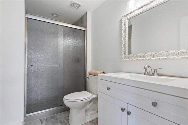 full bathroom featuring toilet, a shower stall, visible vents, and vanity