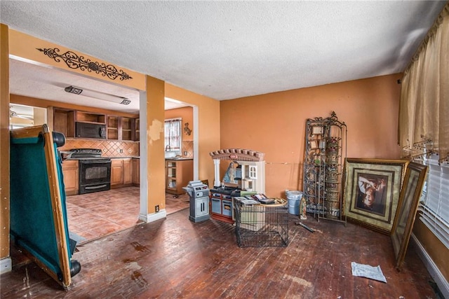 living area with a textured ceiling and hardwood / wood-style flooring