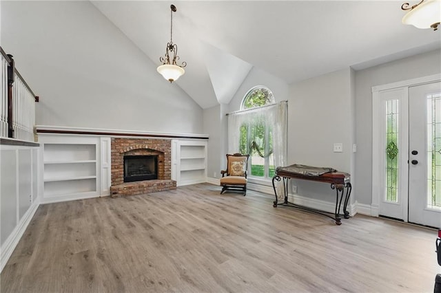 14953 W 124th Ter, Olathe, KS 66062 - entryway with light wood-style flooring, a fireplace, baseboards, and high vaulted ceiling