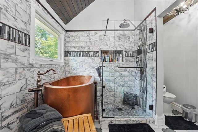 14953 W 124th Ter, Olathe, KS 66062 - bathroom featuring marble look tiles, lofted ceiling, a freestanding bath, a stall shower, and tile walls