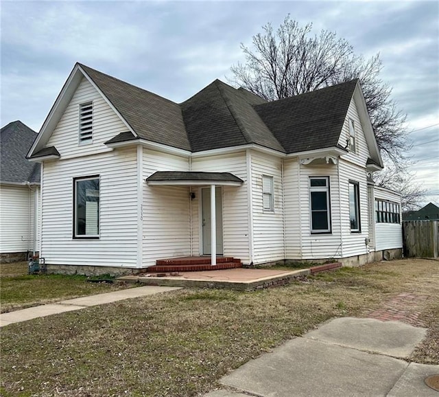 view of front of property featuring roof with shingles