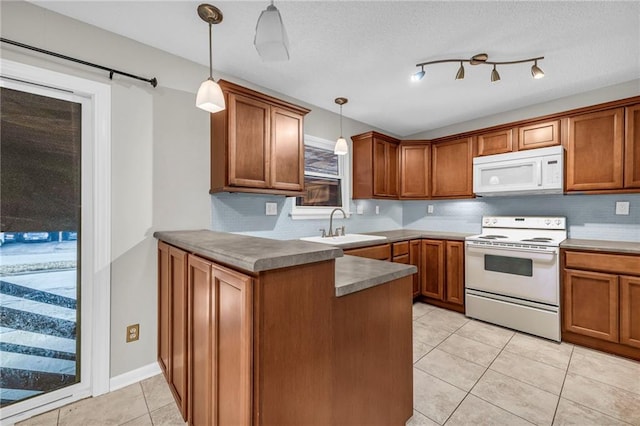 kitchen featuring brown cabinetry, white appliances, and a sink